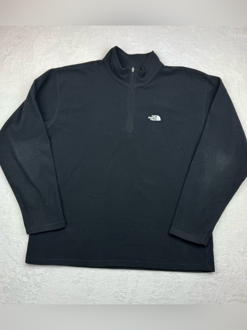 The North Face black quarter-zip fleece pullover. Men’s size L.
